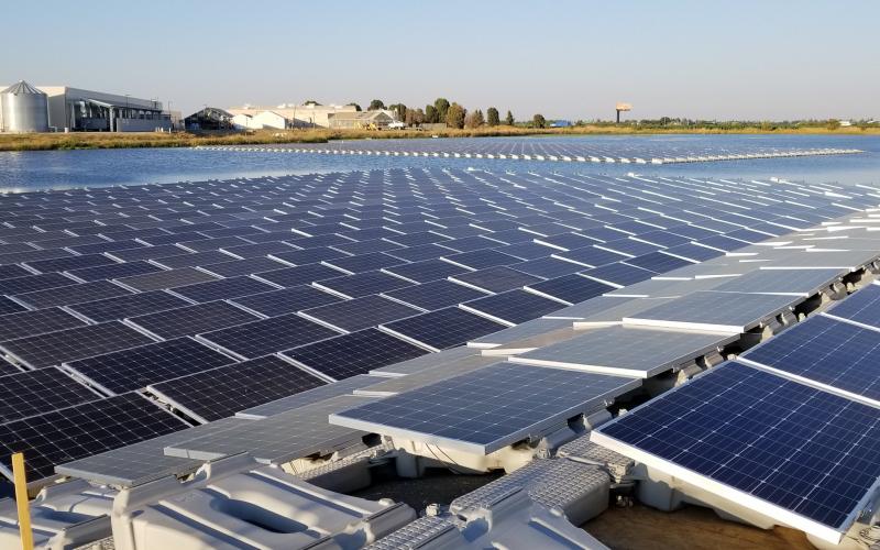 close-up floating solar array on irrigation pond | Salad Cosmo